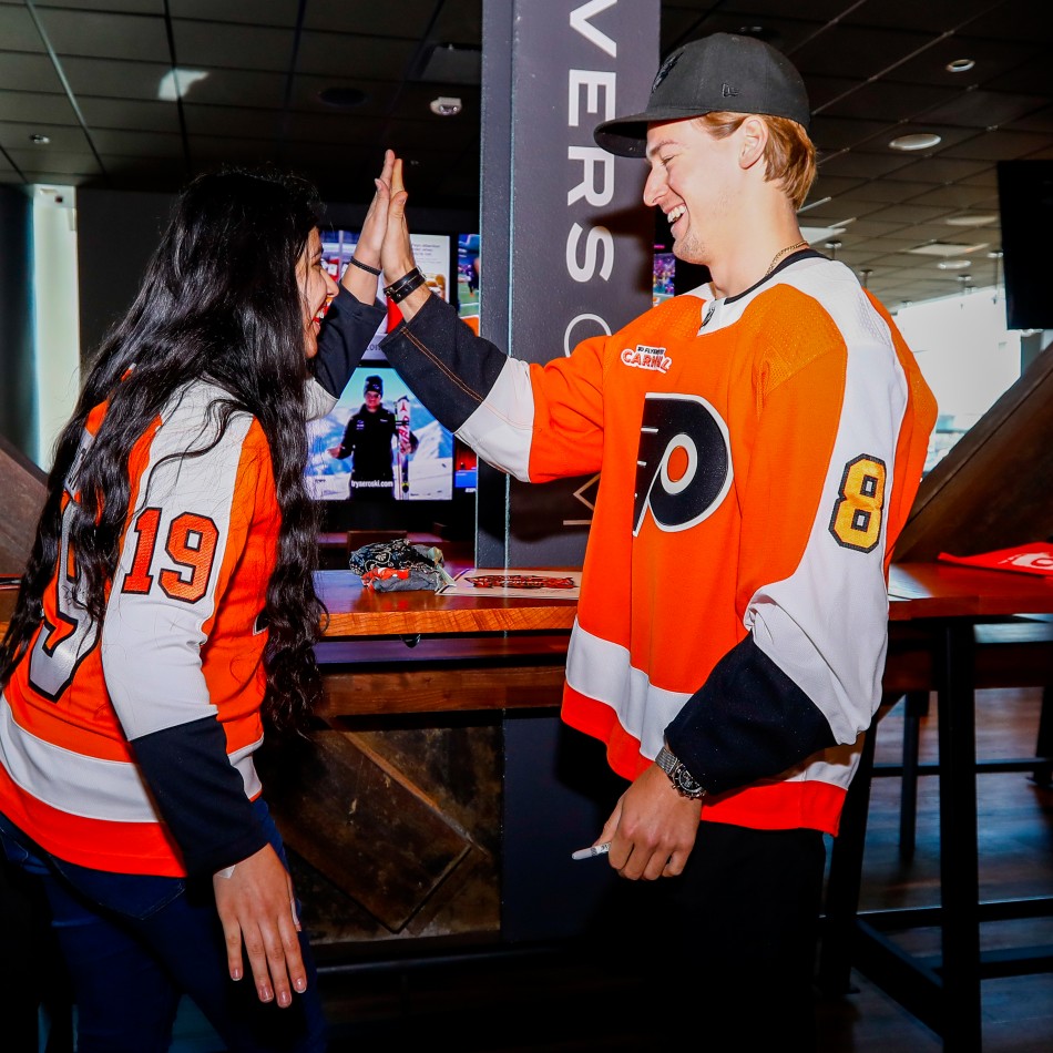 Fan engaging with player at Flyers Wives Carnival
